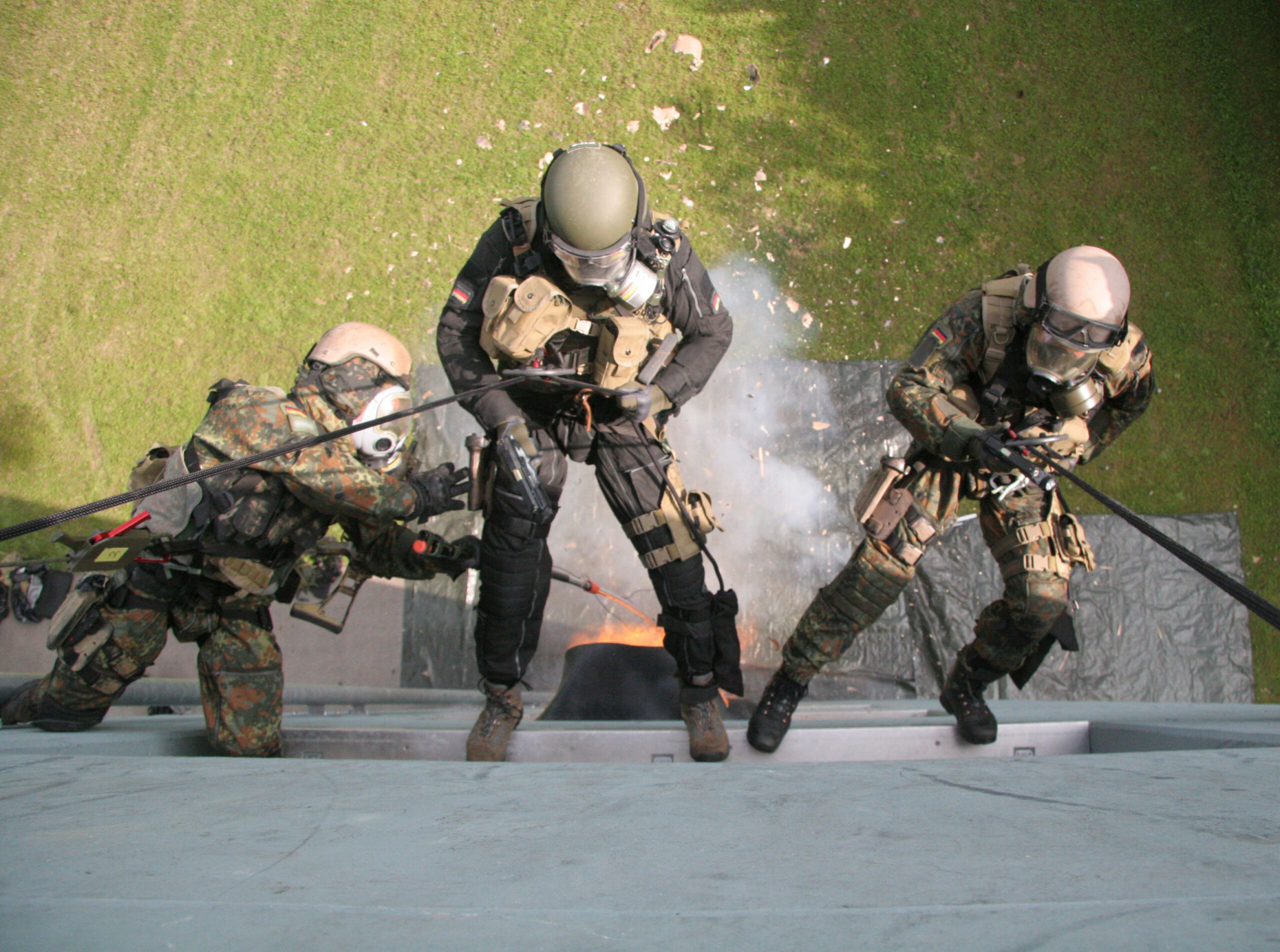 Ein Trupp des Kommando Spezialkräfte seilt sich vom Gebäude ab, während der Breacher eine Zugangssprengung an einem der Fenster durchführt, um in das Gebäude einzudringen. Foto: Bundeswehr / PIZ Heer
